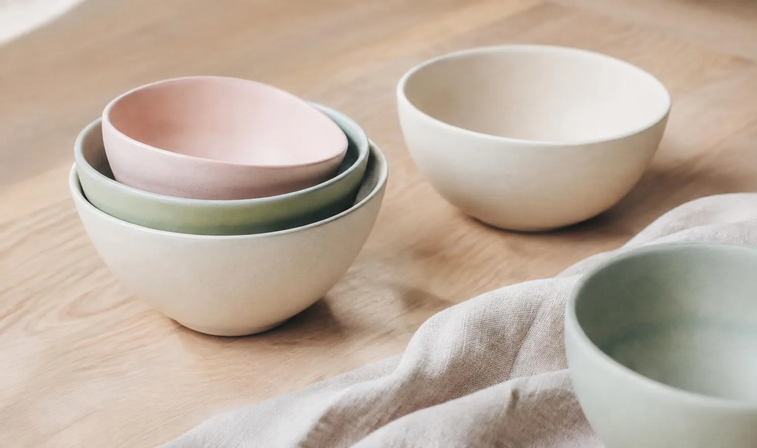 Nested ceramic bowls in ivory, mint and blush