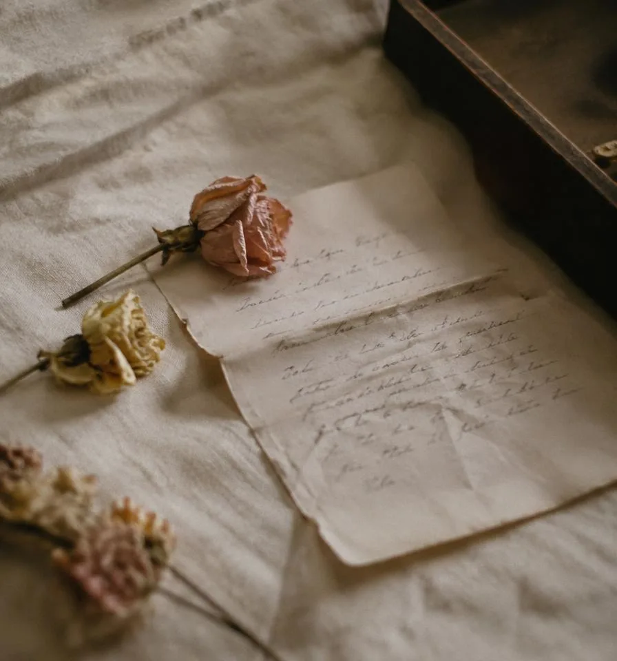 Folded handwritten letter with dried flowers